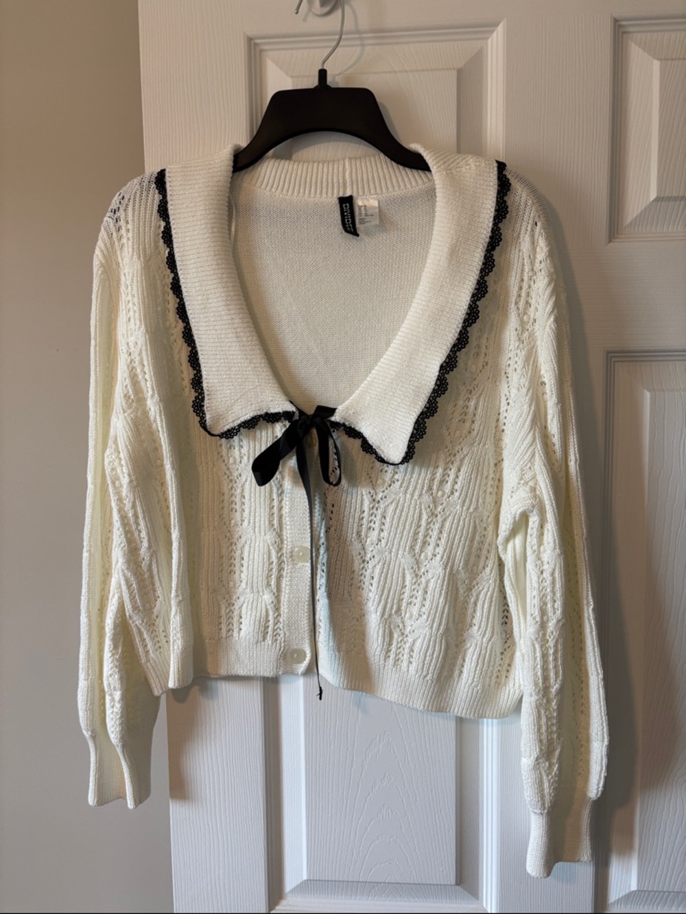 Divided Ivory Knit Cardigan with Black Trim and Bow Accent